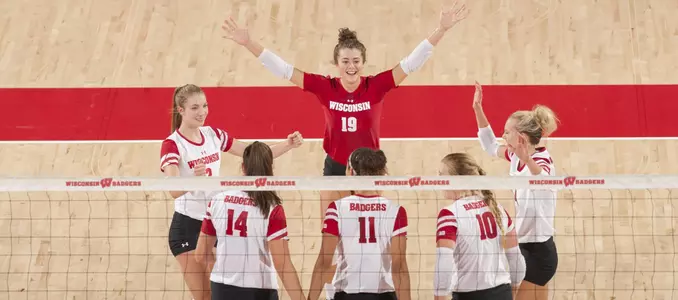 The Badgers celebrate a point on the court.