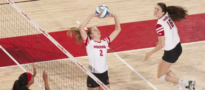 Sydney Hilley sets the ball while Dana Rettke runs behind her on approach.