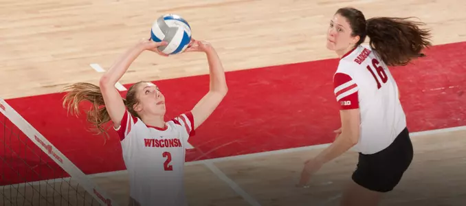 Sydney Hilley sets the ball while Dana Rettke runs behind her on approach.