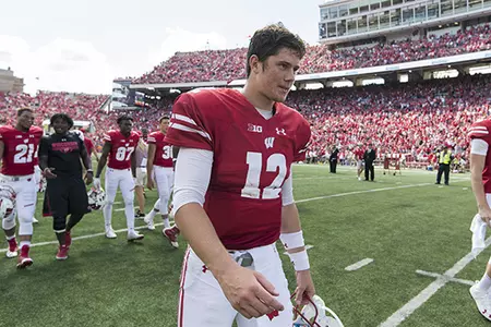 Photo of Wisconsin football quarterback Alex Hornibrook walking off the field after the Badgers defeated Georgia State at Camp Randall Stadium in 2016