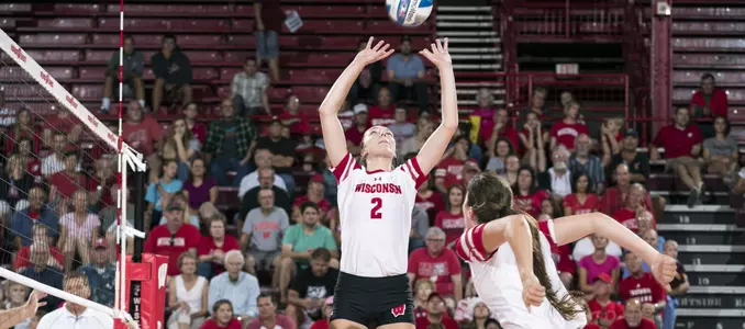 Sydney Hilley sets the ball while Danielle Hart waits to attack.