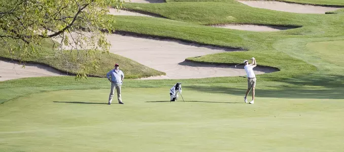 Photo of Jordan Hahn and head coach Michael Burcin at the 2017 Badger Invitational at University Ridge Golf Course