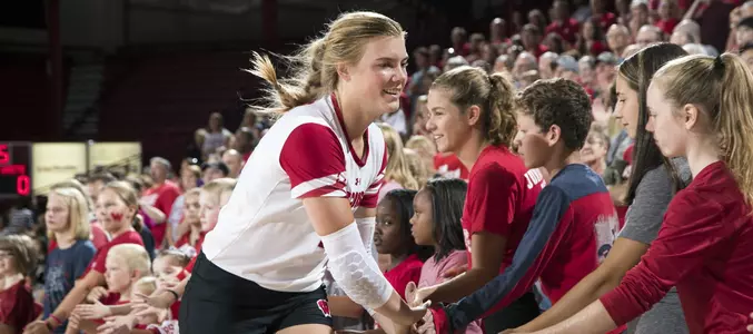 Mariah Whalen slaps the hands of the children that line the court during starting lineups.