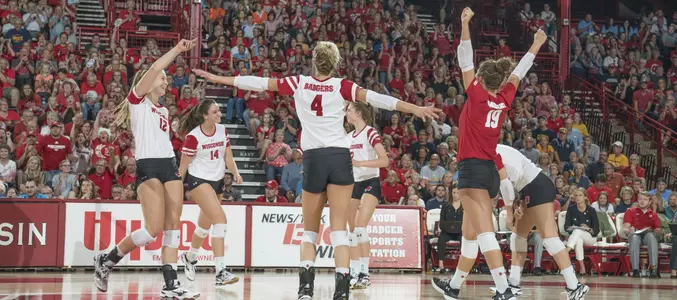 The Badger volleyball team celebrates a point on the court.