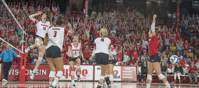 The Badgers celebrate a point on the court.