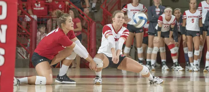 Sarah Dodd passes the ball while M.E. Dodge covers her pass.