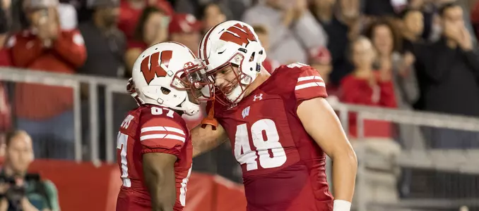Photo of Quintez Cephus and Troy Fumagalli celebrating in endzone after touchdown in football game vs. Utah State 2017