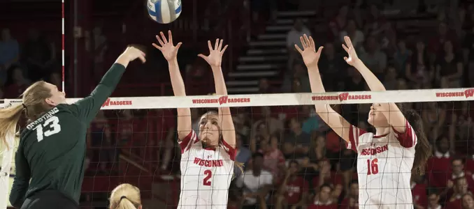 Sydney Hilley and Dana Rettke attempt to block a Michigan State attack.