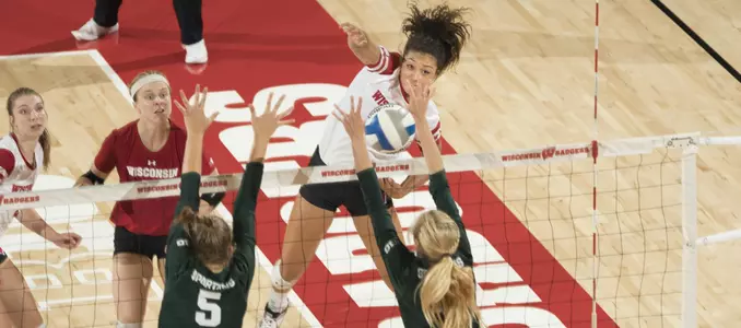 Lauryn Gillis goes for a line shot against to MSU blockers.