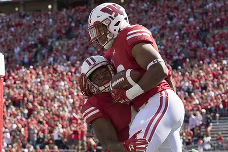 Photo of Jonathan Taylor celebrating with a teammate during football game vs. Florida Atlantic 2017