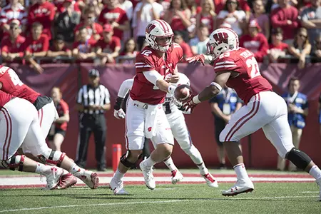 Photo of Alex Hornibrook hand off to Jonathan Taylor football vs. Florida Atlantic 2017