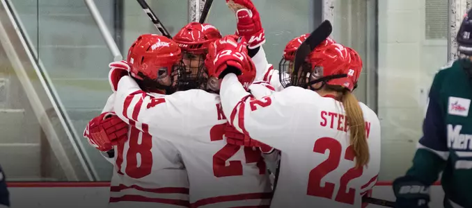 Women's hockey celebrates a goal in its 4-0 win over Mercyhurst