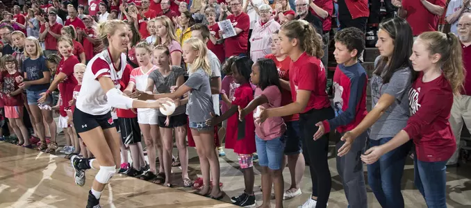 Kelli Bates slaps the hands of the children that line the court during starting lineups.