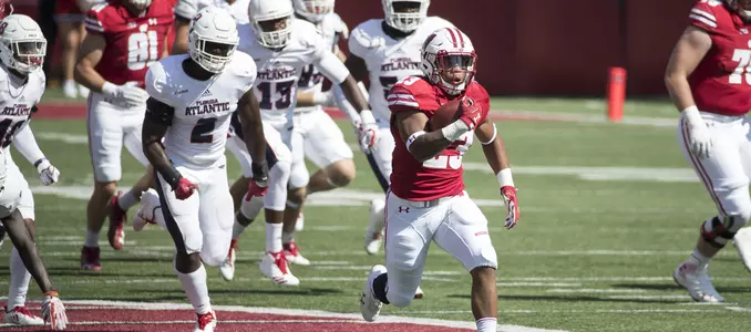 Photo of Jonathan Taylor scoring a touchdown in Football game vs. Florida Atlantic 2017