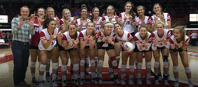 The Badger volleyball team celebrates the HotelRED Invitational title with a team photo.