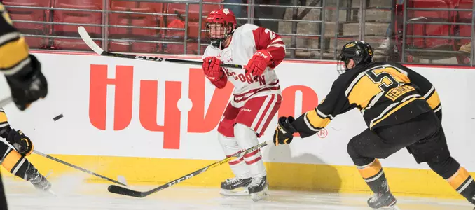 Sean Dhooghe passes the puck