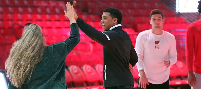 D'Mitrik Trice high-fives a fellow UW-Madison student during 2018 Swish Upon A Cure