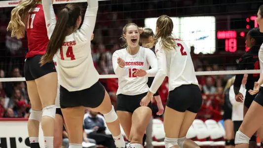 Nicole Shanahan celebrates a point with her teammates on the court.