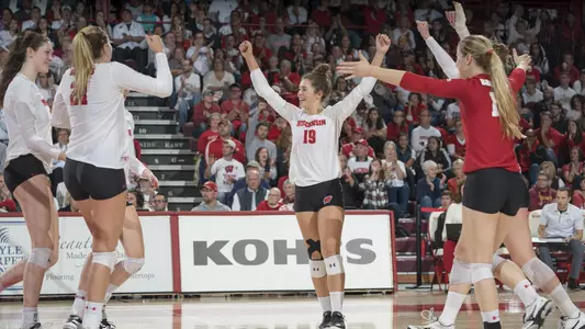 The Badgers celebrate a point on the court.