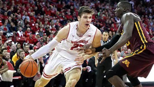 Ethan Happ dribbles against Minnesota