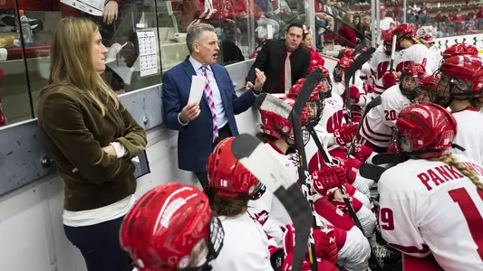 Mark Johnson talks to UW women's hockey team on the bench during game vs. Lindenwood at LaBahn Arena 2018