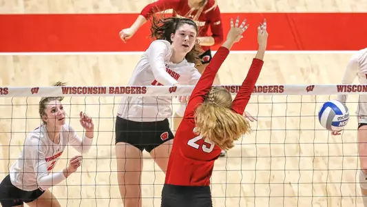 Dana Rettke hits the ball past a Nebraska blocker