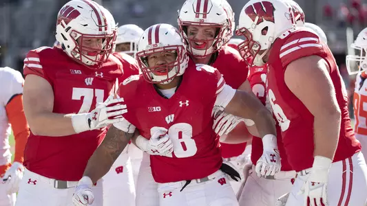 Taiwan Deal is congratulated by UW teammates during Wisconsin's football game vs. Illinois at Camp Randall Stadium on Oct. 20, 2018