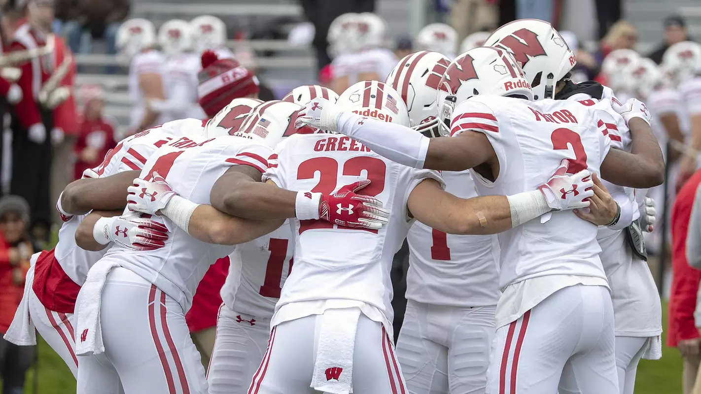 Team huddle of Wisconsin football players at Northwestern 2018
