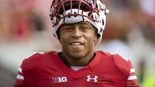 Jonathan Taylor looks at camera with helmet on top of his head during football 2018