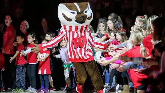 Bucky Badger high fives kids at volleyball vs. Iowa 2018