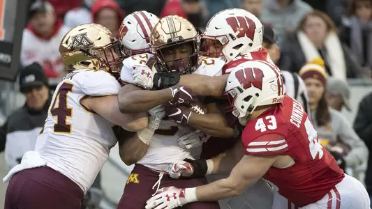 Wisconsin defense, Ryan Connelly, and teammates tackles Minnesota ball carrier Nov. 24, 2018