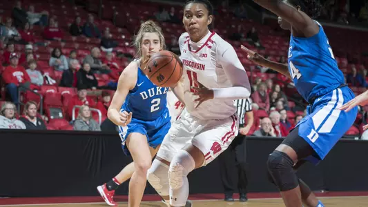 Marsha Howard drives to the basket between two Duke defenders.