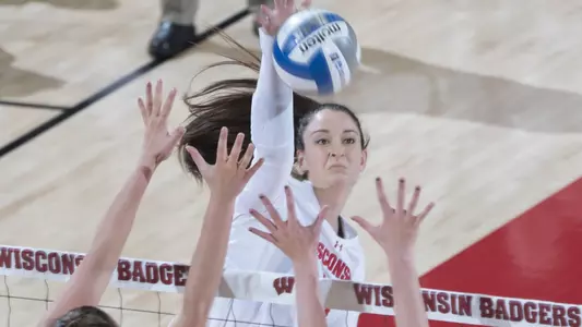 Madison Duello attacks the ball through two Green Bay blockers