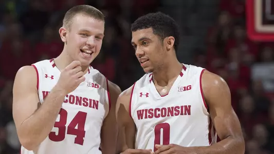 Wisconsin Badgers guard D'Mitrik Trice (0) talks to teammate Brad Davison (34) during an NCAA college men's basketball game against the Coppin State Eagles Tuesday, November 6, 2018, in Madison, Wis. The Badgers won 85-63. (Photo by David Stluka)