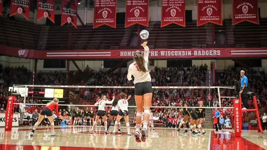 Madison Duello serves the bal from the baseline.
