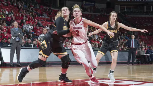 Kelly Karlis drives to the basket past an Oshkosh defender.