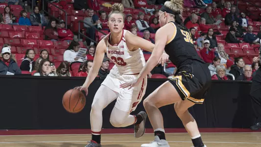 Courtney Fredrickson dribbles past an Oshkosh defender.