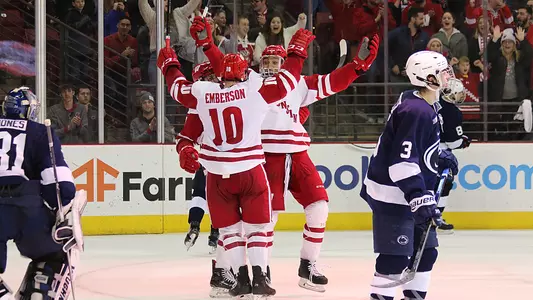 K'Andre Miller and Ty Emberson celebrate game-winning goal