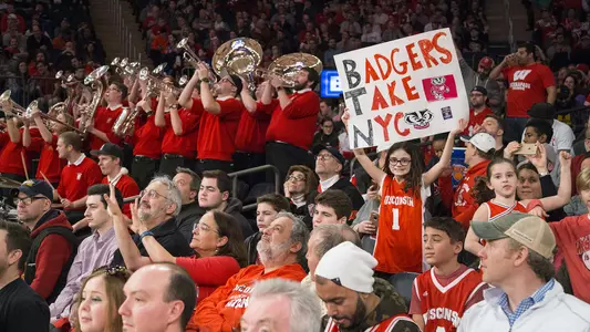 Young girl fan holding sign that reads "Badgers Take New York" at Madison Square Garden during Wisconsin men's basketball game in 2017 against Rutgers