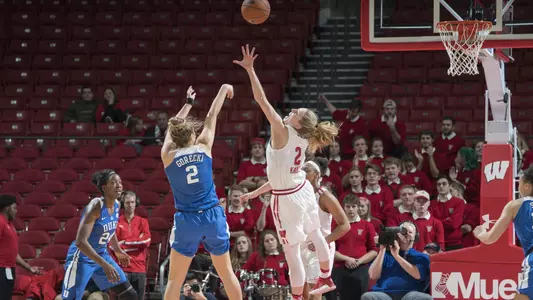 Kelly Karlis goes up for a block against a Duke player.