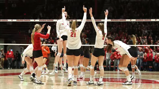 The Badgers celebrate a point on the court against Pepperdine.