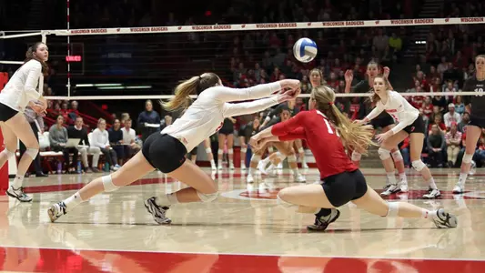 Grace Loberg and Tiffany Clark both go after a dig during a match.