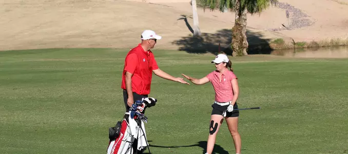 Head coach Todd Oehrlein and senior Becky Klongland celebrate a good shot at the 2018 Westbrook Invitational (Feb. 25, 2018)