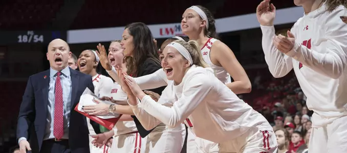 The Badger bench celebrates during a game.