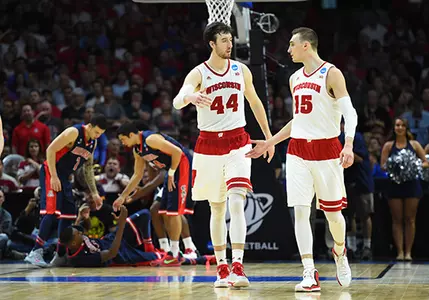 28 March 2015: Forward Frank Kaminsky (44) of the Wisconsin Badgers and Forward Sam Dekker (15) of the Wisconsin Badgers start to celebrate as time winds down during the NCAA Division 1 Men's Basketball Championship Elite Eight game between the Arizona Wildcats and the Wisconsin Badgers at STAPLES Center in Los Angeles, CA. Wisconsin defeated Arizona 85-78 to win the West Regional Championship.