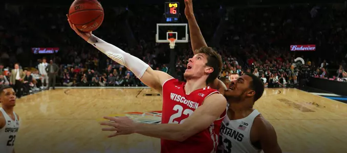 Ethan Happ goes for a layup during a game against Michigan State