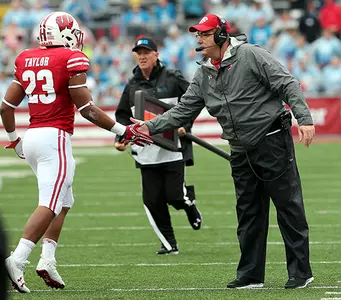 Jonathan Taylor high fives with Paul Chryst football vs. Purdue 2017