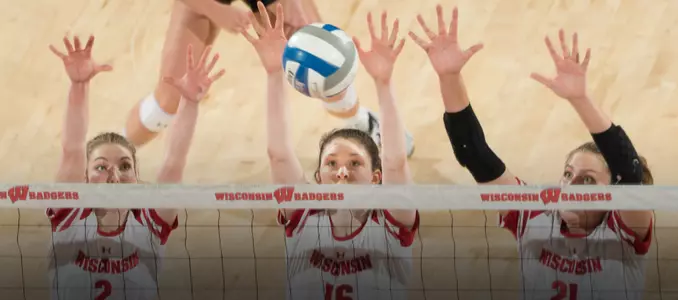Sydney Hilley, Dana Rettke and Grace Loberg go up for a block against Loyola.