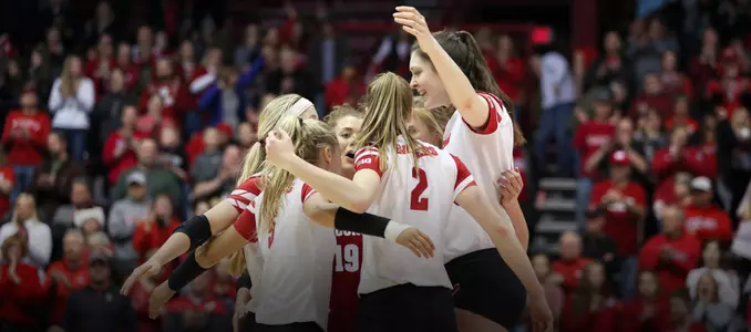 The Badgers celebrate winning a point on the court in the UW Field House.