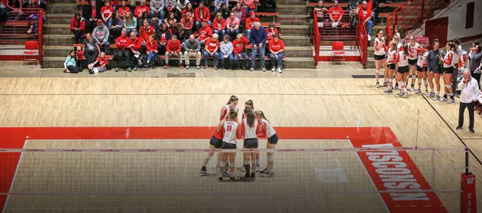 The Badgers huddle up on the floor of the UW Field House before playing.